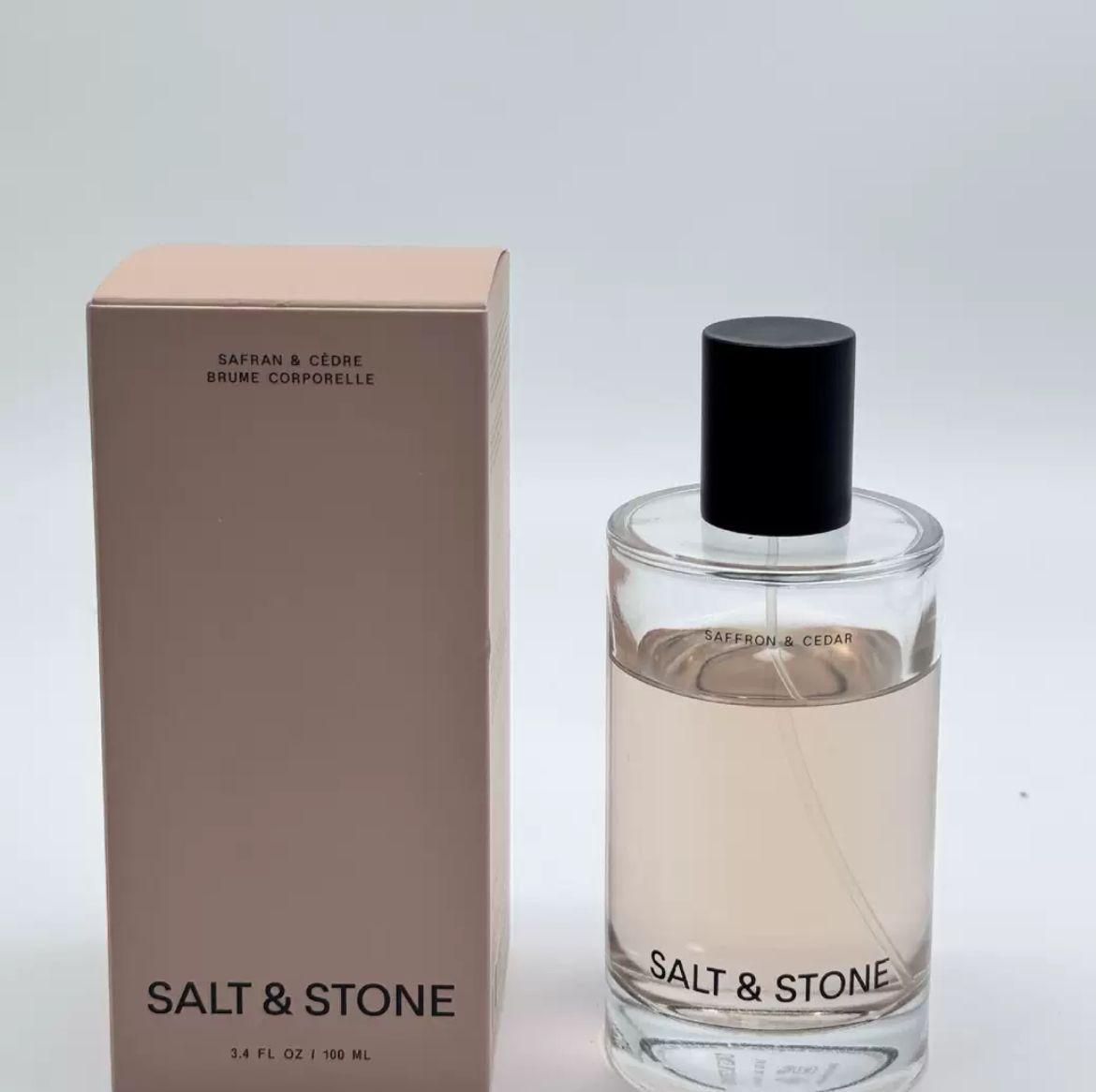Salt & Stone Body Spray, featuring saffron and cedar fragrances, is a skincare-infused perfume hair and body spray suitable for both men and women. The moisturizing fragrance contains glycerin and red algae, is vegetarian, and is non-irritating.