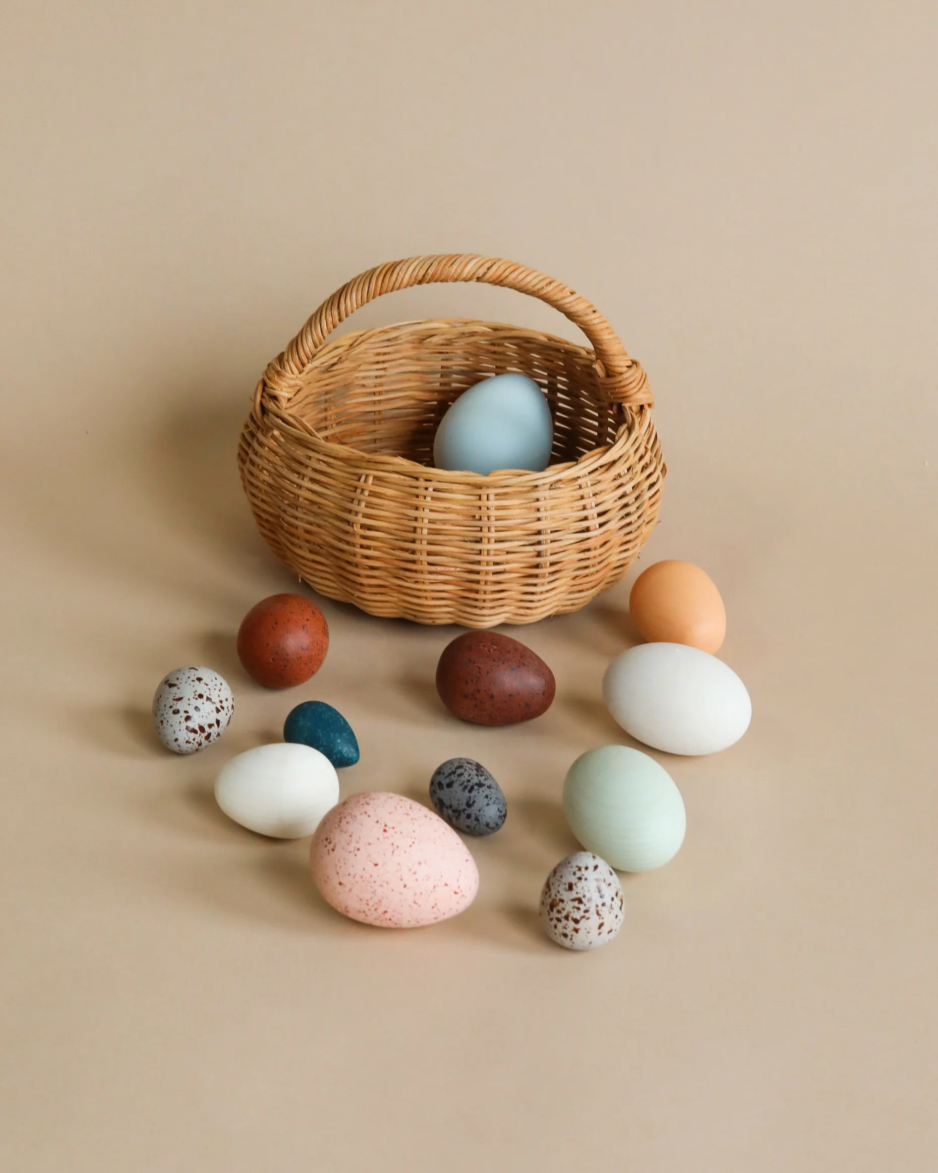 A Dozen Wooden Bird Eggs In A Basket
